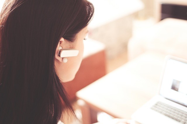 Woman with bluetooth headphones